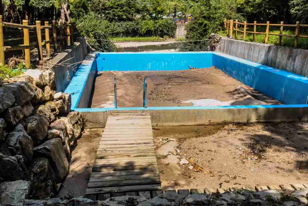 An abandoned swimming pool filled in with dirt