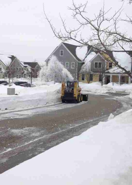 Snow plow plowing driveway snow
